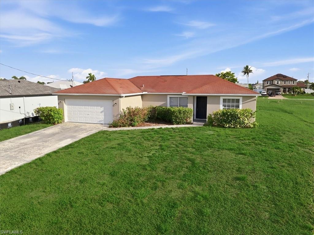 Single-story stucco exterior with a terra cotta tile roof