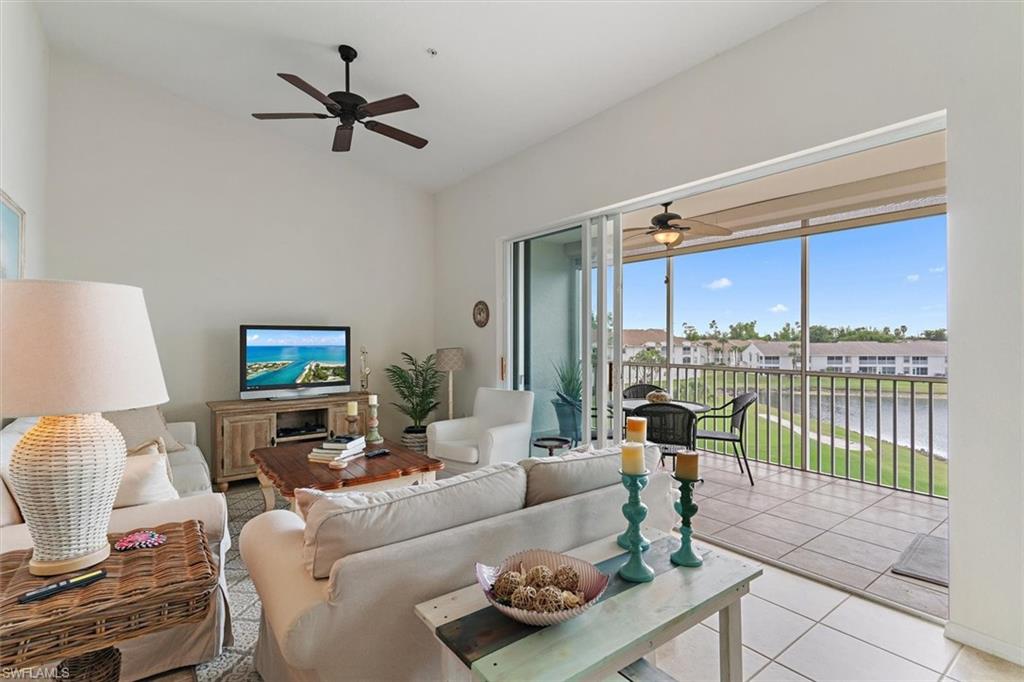 Spacious living area featuring vaulted ceilings and a ceiling fan