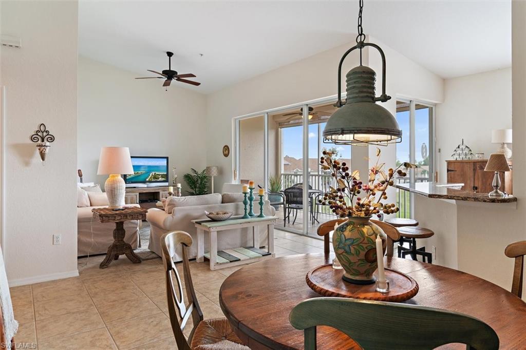 Open-concept living area with tile flooring and vaulted ceilings