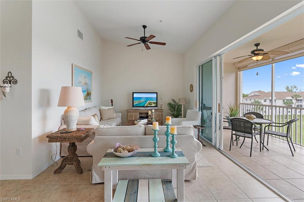 Open-concept living area featuring high vaulted ceilings and tile flooring