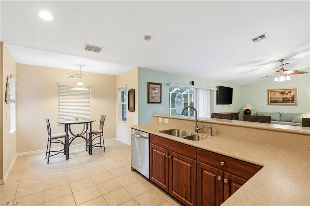 Virtually Staged Open-concept living space featuring vaulted ceilings, light-toned carpeting, and a glass sliding door to the exterior