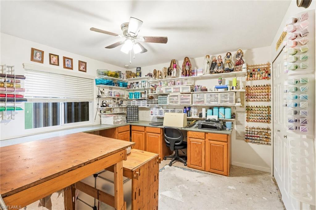Virtually Staged Room featuring extensive built-in shelving, a ceiling fan, and a window with horizontal blinds