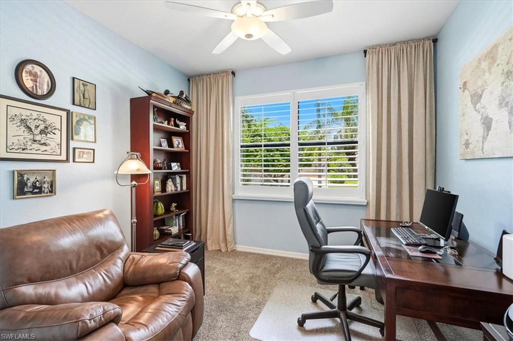 Light blue wall paint complementing white trim and a ceiling fan
