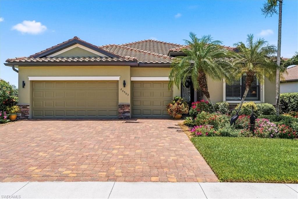 Mediterranean-style residence featuring a tile roof and stucco exterior