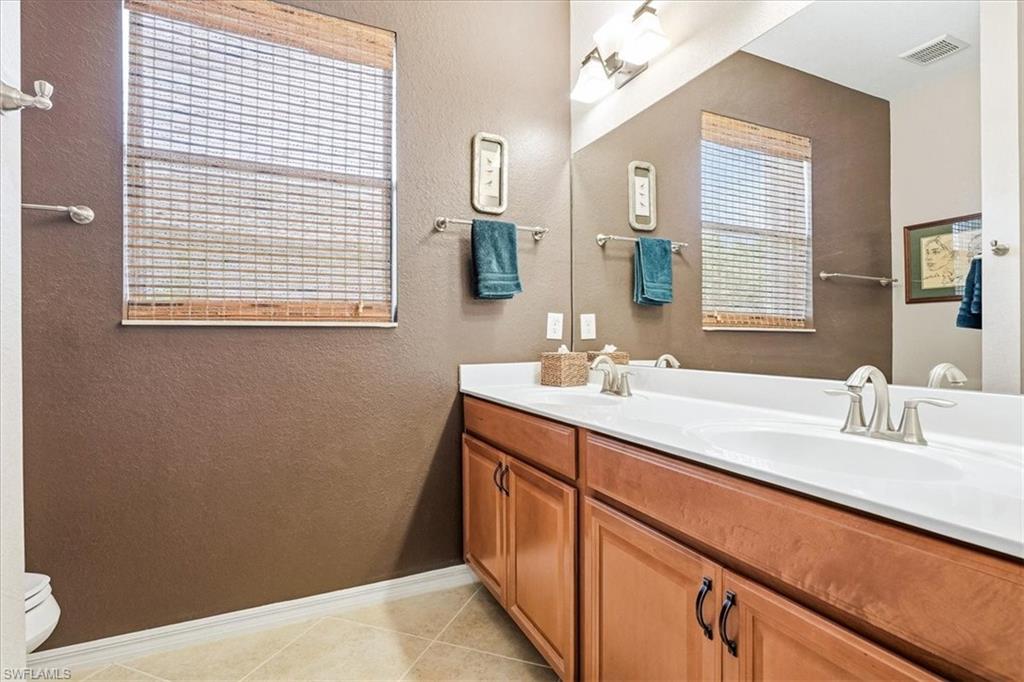 Dual vanity with integrated sinks and brushed nickel faucets