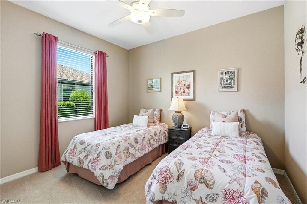 Carpeted room featuring neutral-toned walls, a ceiling fan with integrated lighting, and a window with blinds