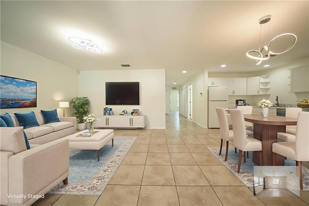 Virtual rendering: Living room featuring light tile patterned floors, recessed lighting, and a chandelier