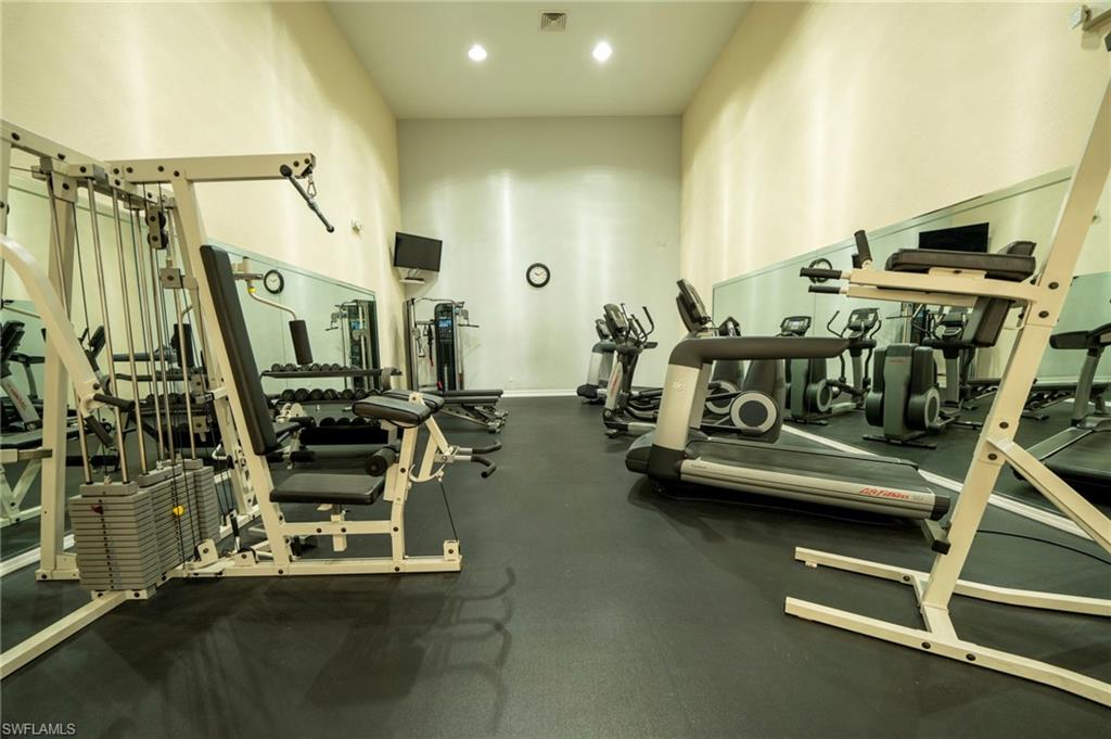 Gym featuring a towering ceiling