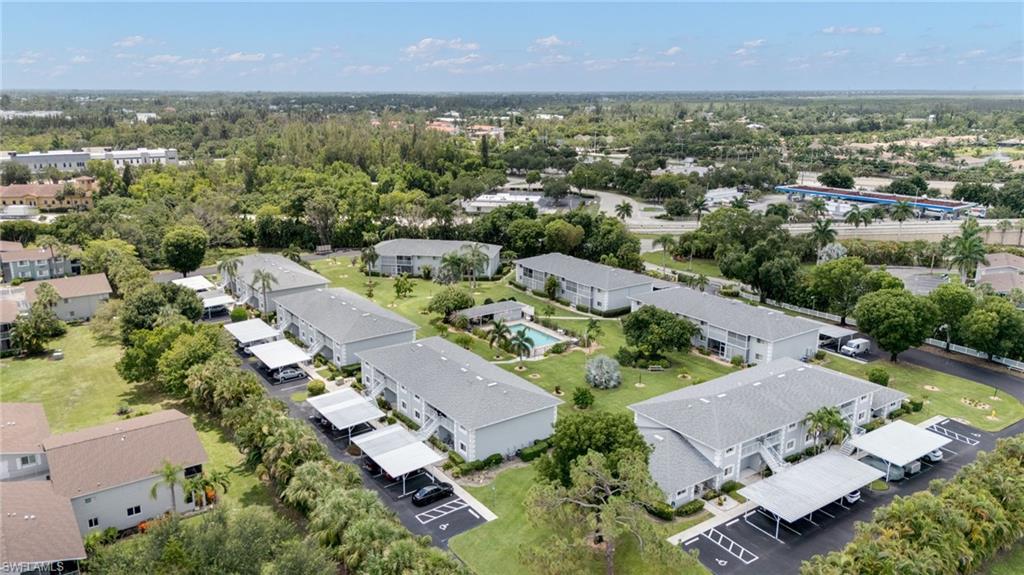 Aerial perspective of a multi-building community featuring uniform architecture and mature landscaping
