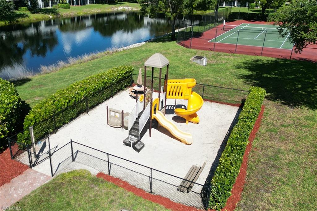 Community jungle gym featuring a water view and a tennis court