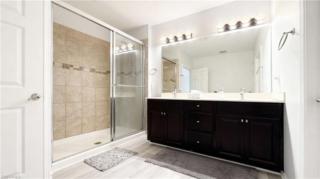 Bathroom with double vanity and a stall shower
