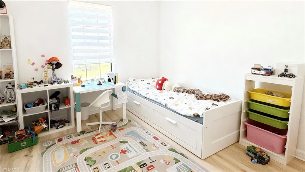 Bedroom with light wood-style floors