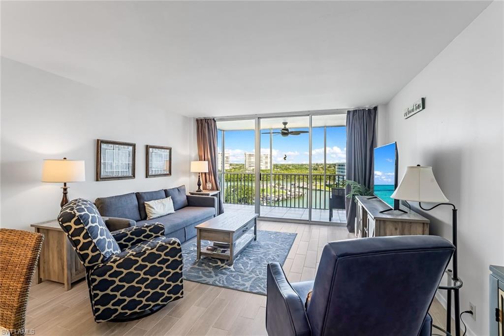 Living rooom with sliding glass doors to lanai over looking pathway to beach.