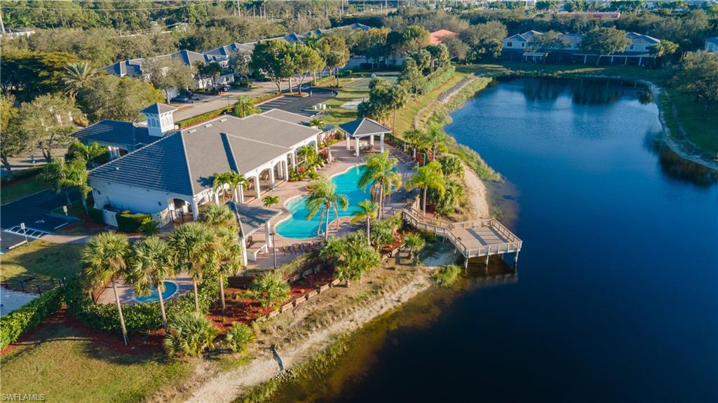 Bird's eye view of a nearby body of water and a pool area