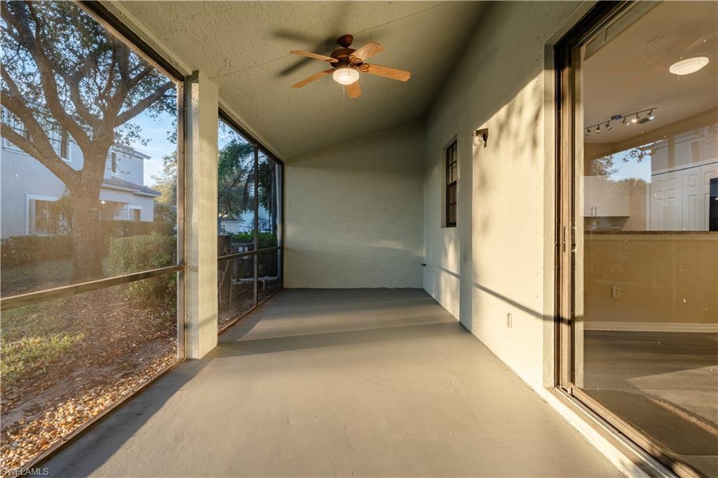 Unfurnished sunroom with a ceiling fan and vaulted ceiling