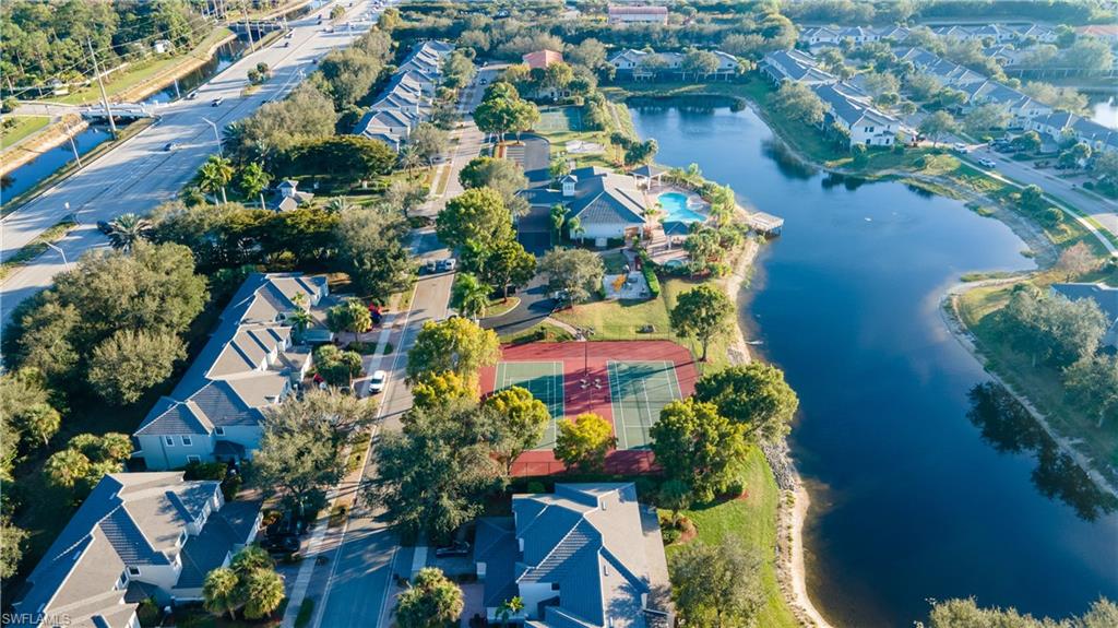 Aerial view of property and surrounding area featuring a nearby body of water