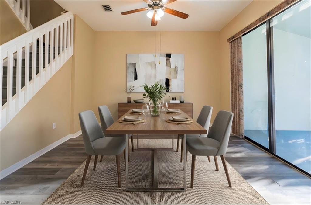 Dining room featuring dark wood-style floors and ceiling fan