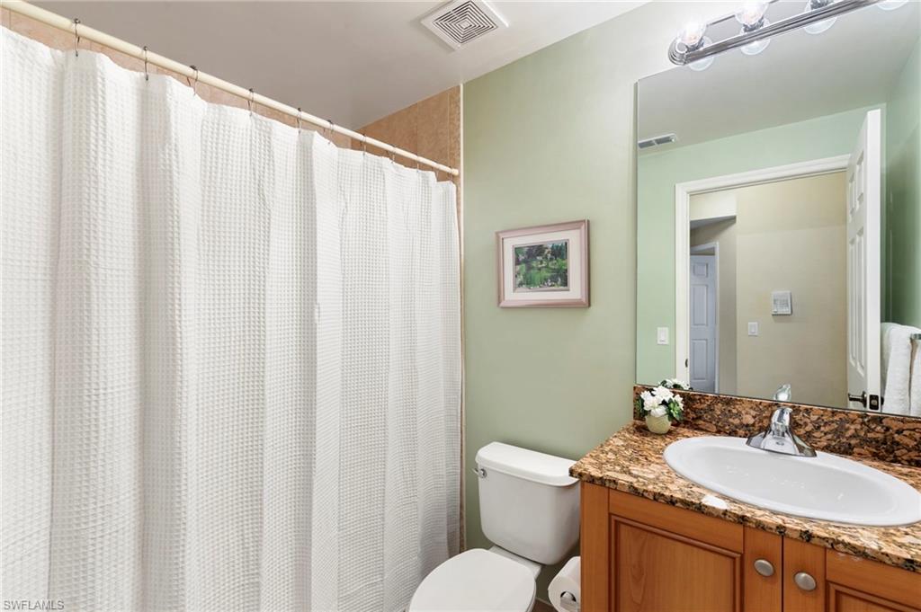 The private guest bath features a large vanity with plenty of storage and tub/shower combo.
