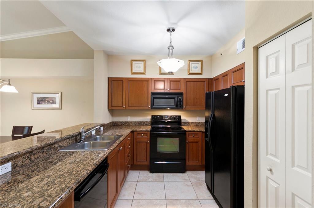 This spotless cullinary space offers granite surfaces and plenty of storage.