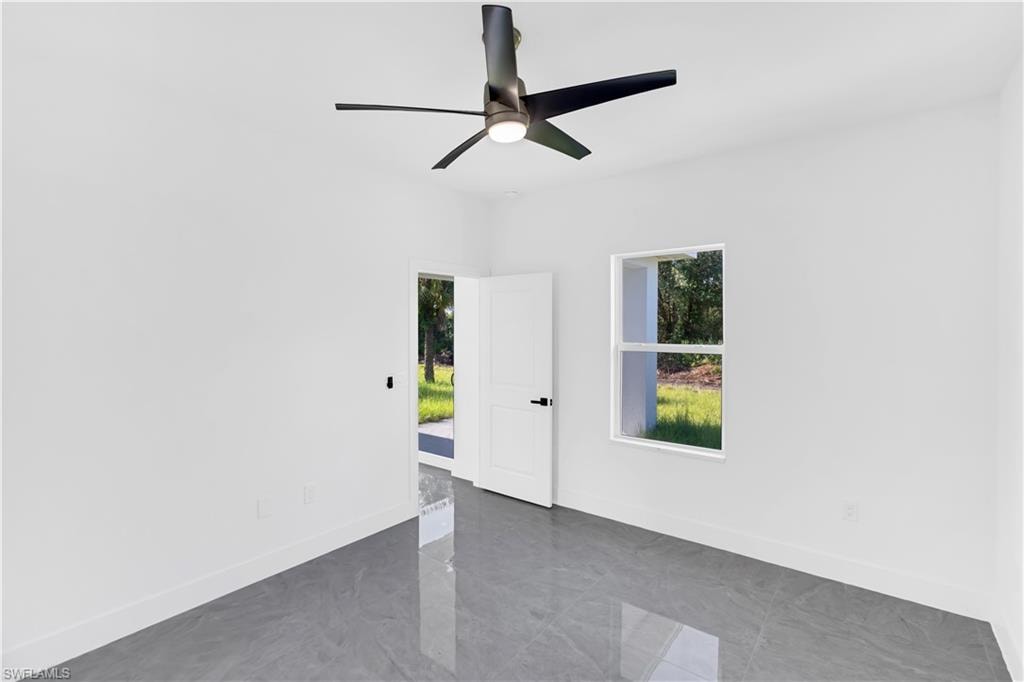 Modern interior space featuring gray polished tile flooring and white walls
