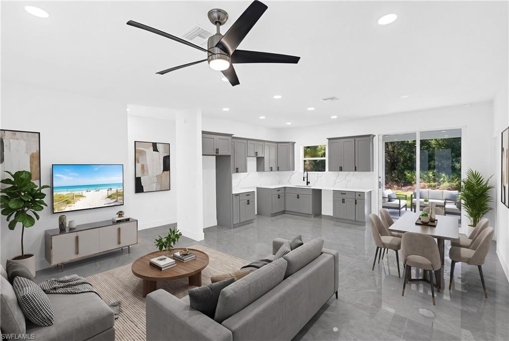 Open-concept  Ai living area with large format tile flooring, recessed lighting, and a modern ceiling fan