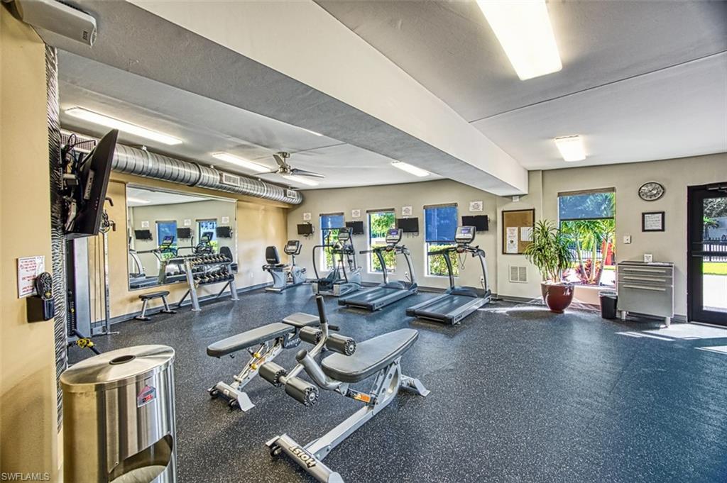 Workout area with ceiling fan and baseboards