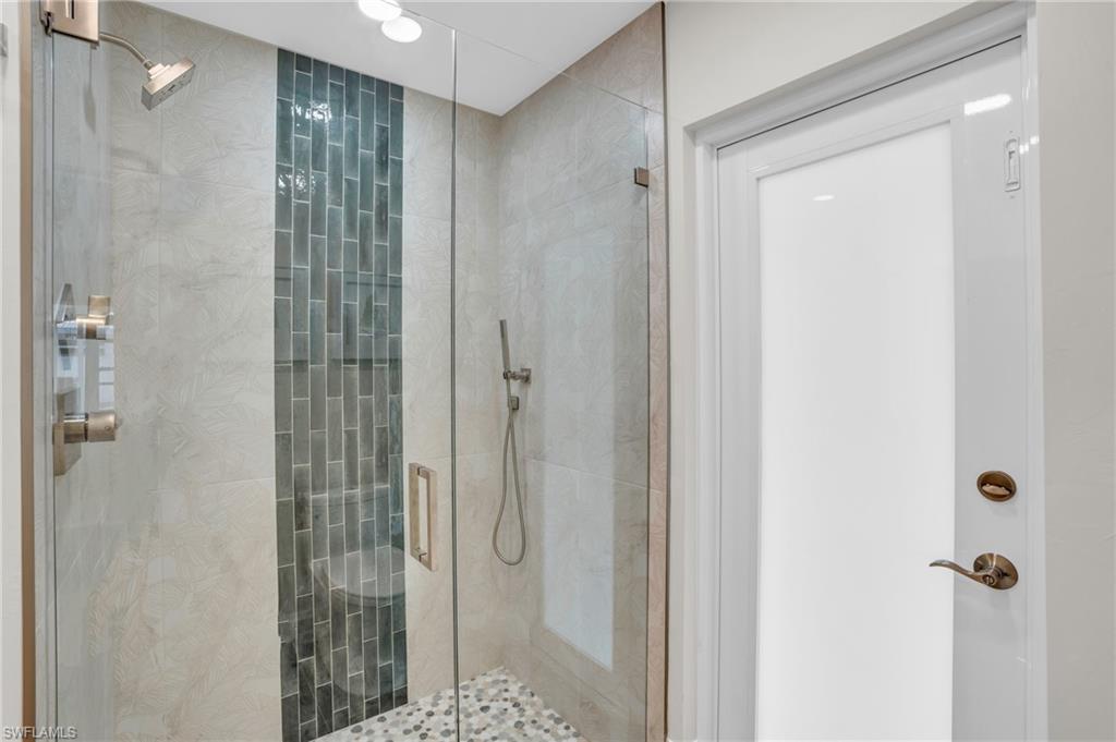 Guest Suite Bathroom Shower with door to the Lanai.  Again, the designer appointments really stand out.