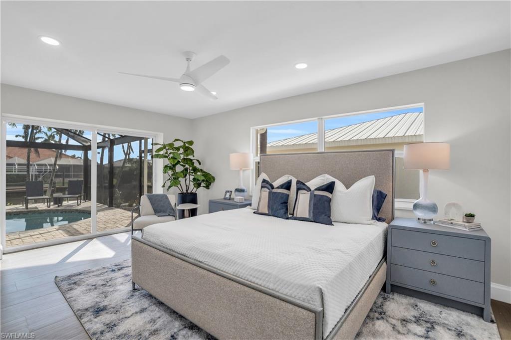 Primary bedroom with the greatest of views of the pool/lanai area.  So much natural light!