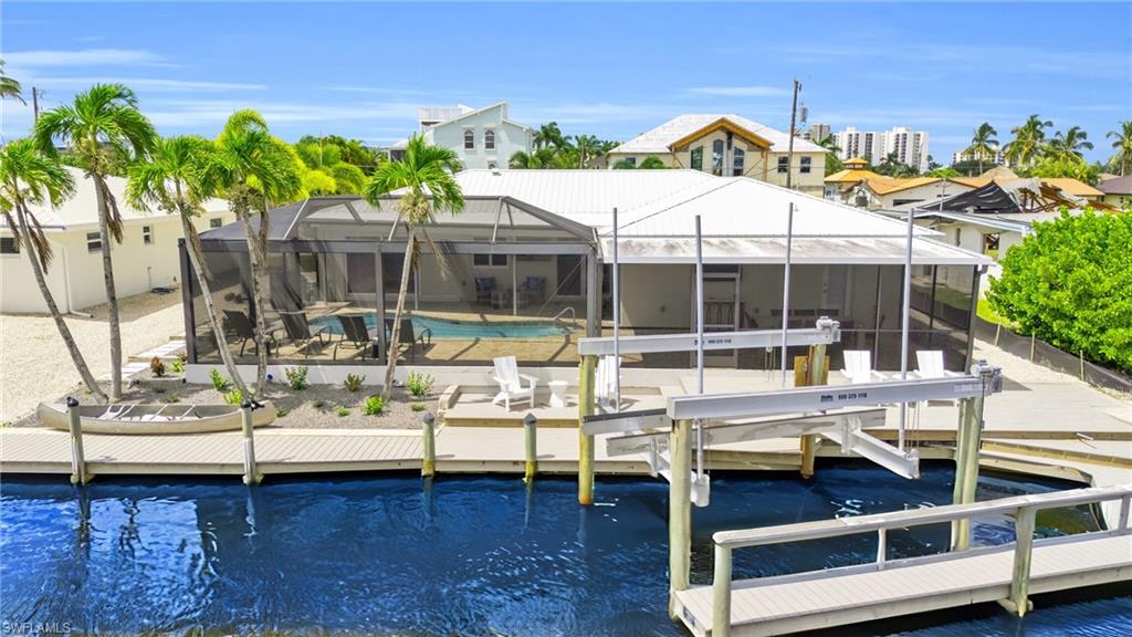 View of the rear of the home featuring a Captains Walk Boat Dock, with a 20,000 pound Boat Lift!  VIRTUALLY ENHANCED