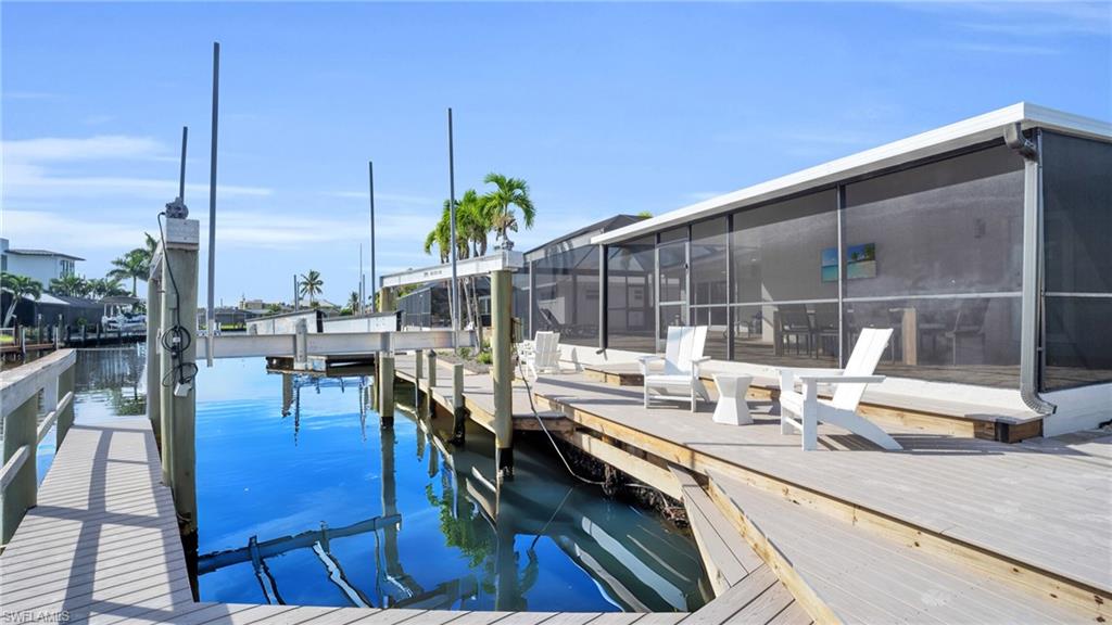 Dock area featuring composite material decking, captains walk dock and 20,000 pound boat lift.      VIRTUALLY ENHANCED -