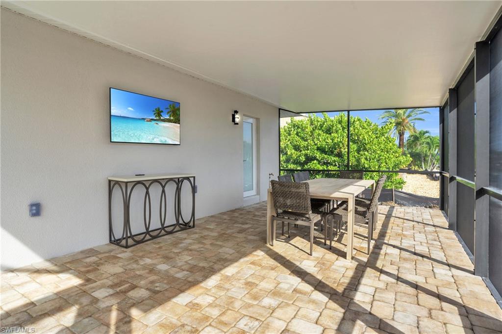 Even more covered screened in pool area off to the side to relax and entertain right along the canal.