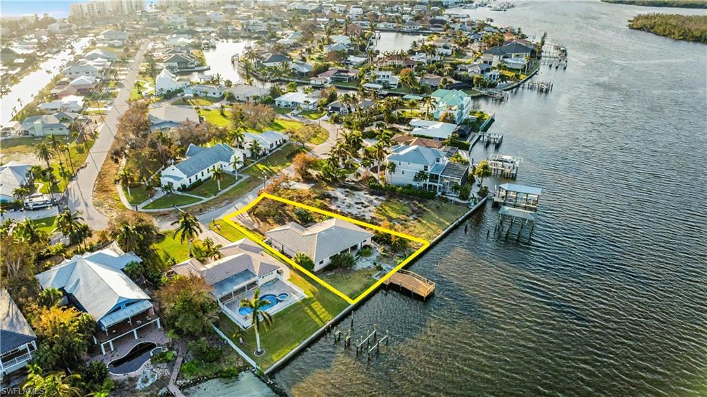 Aerial perspective highlighting the property's desirable waterfront position and proximity to the Gulf - Virtually Edited Image