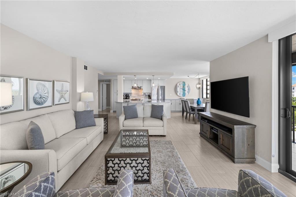 Open-concept living space featuring light wood-finish flooring, recessed lighting, and a neutral color palette