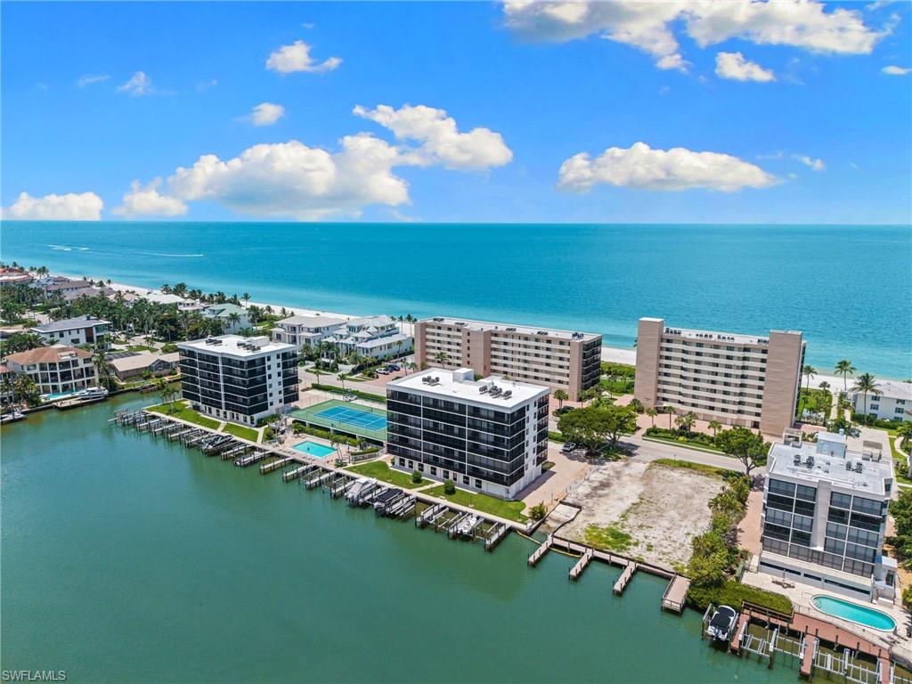 Waterfront condominiums featuring private boat slips, onsite swimming pools, tennis courts, and direct beach access to the Gulf of Mexico