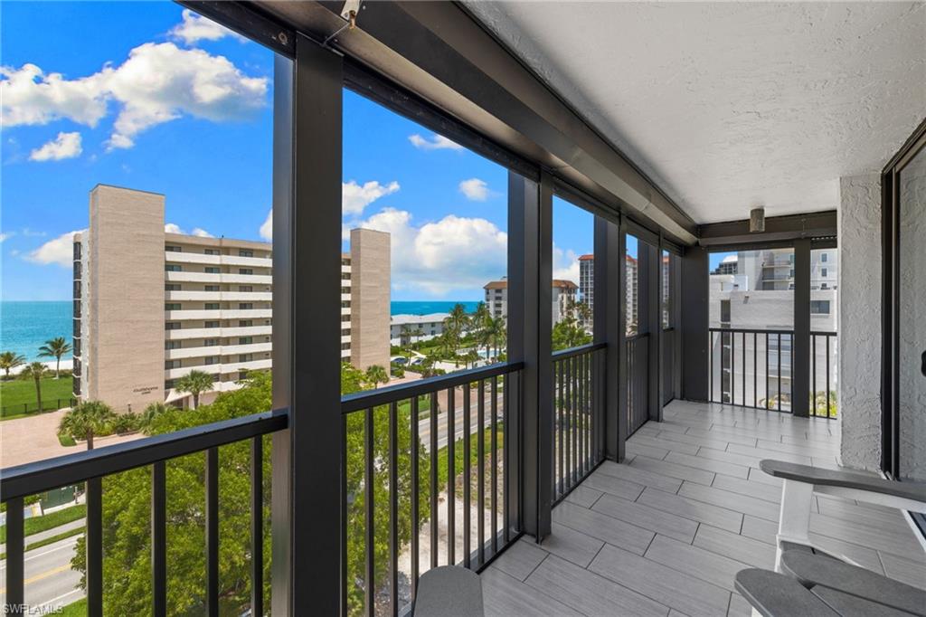 Spacious balcony featuring tile flooring and black metal railings