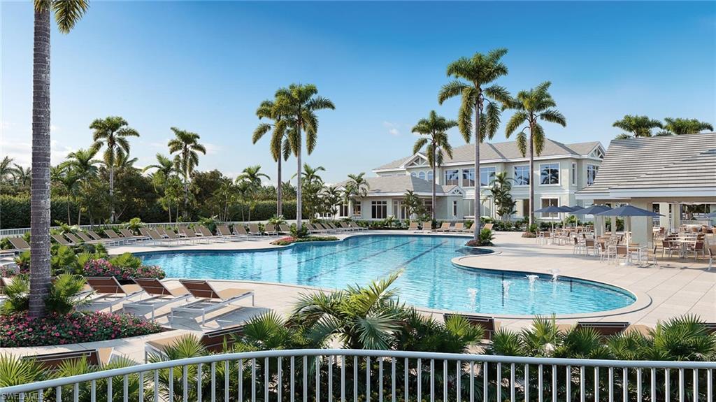 Resort-style swimming pool featuring a curved design, lap lanes, and surrounding lounge chairs