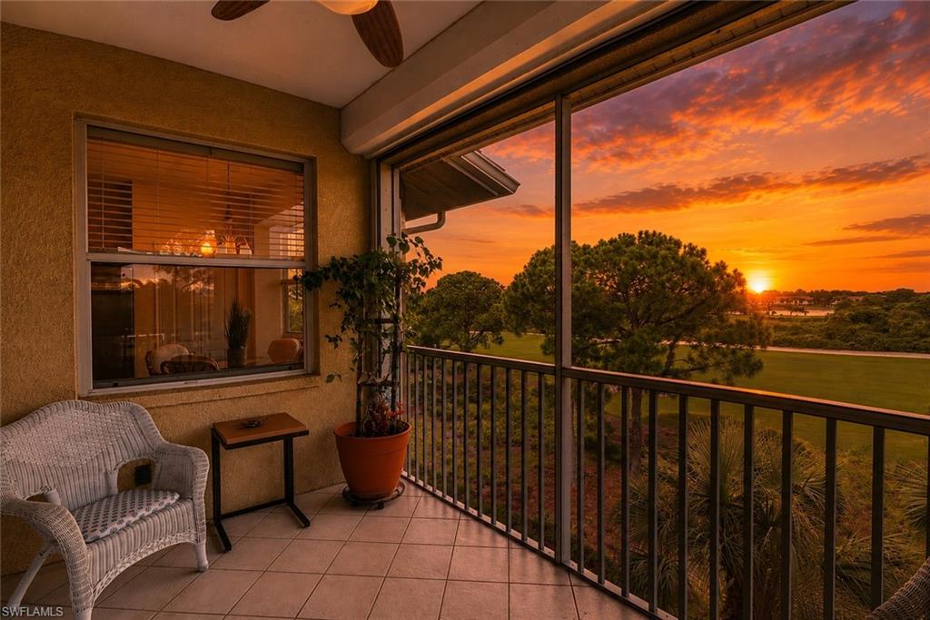 Screened balcony featuring tiled flooring and a metal railing