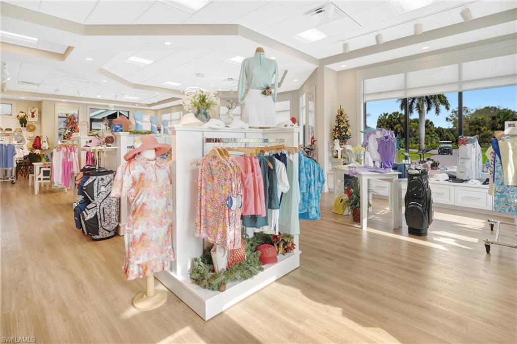 Bright retail space featuring wood-finish flooring, recessed lighting, and large windows