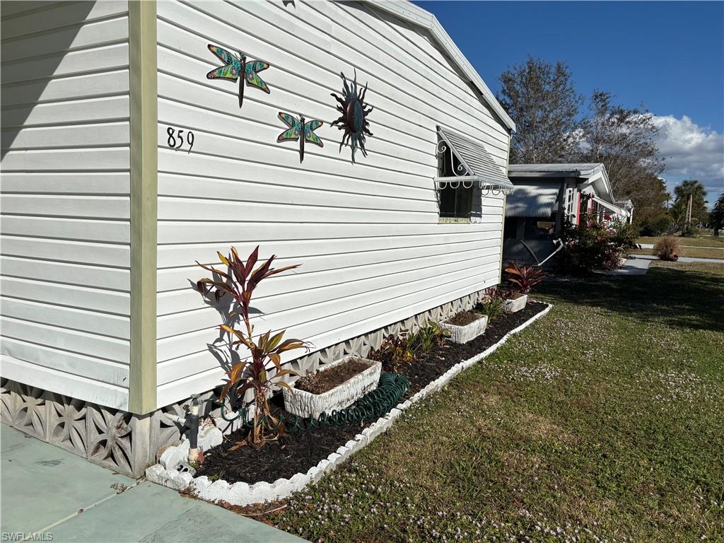 View of side of property with a lawn