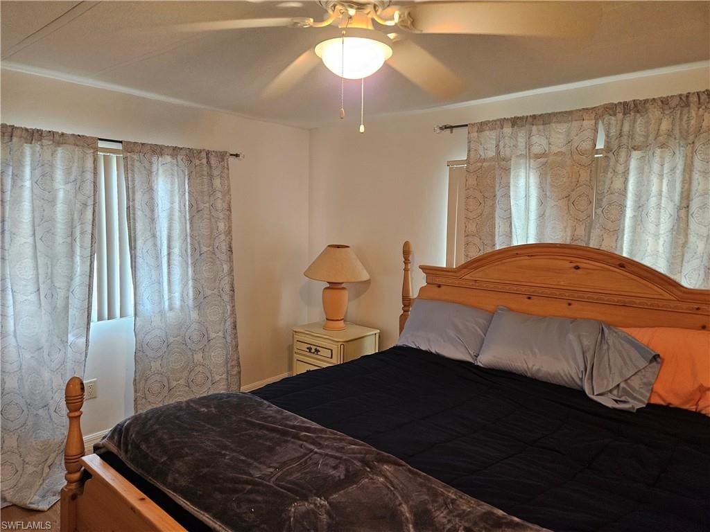 Bedroom featuring ceiling fan and wood-type flooring