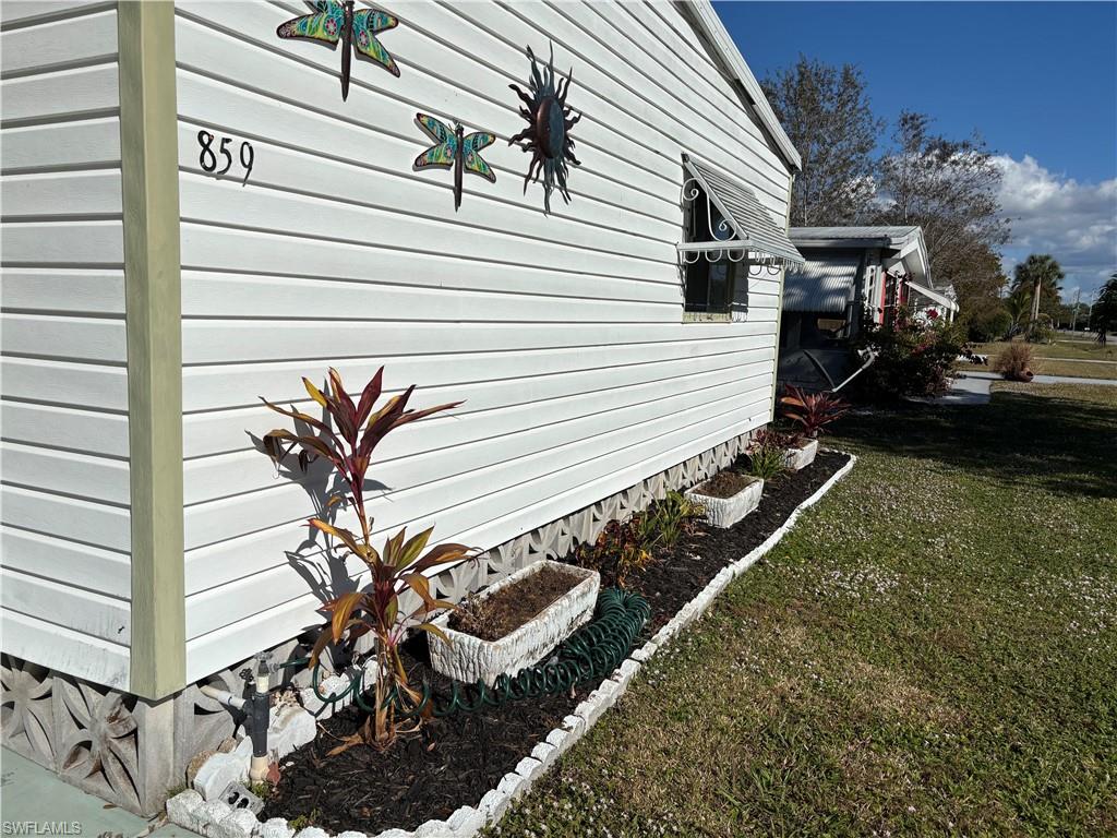View of home's exterior with a yard