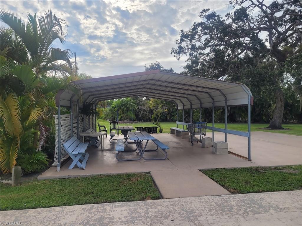 View of community with a patio and a lawn