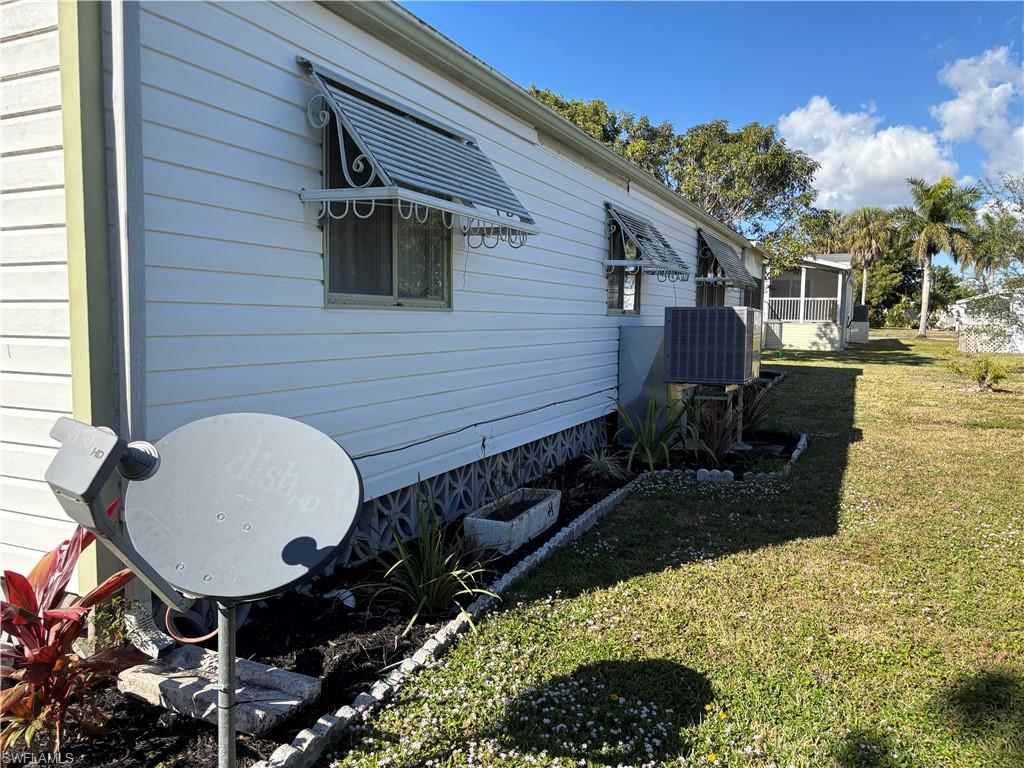 View of home's exterior featuring a yard and a sunroom