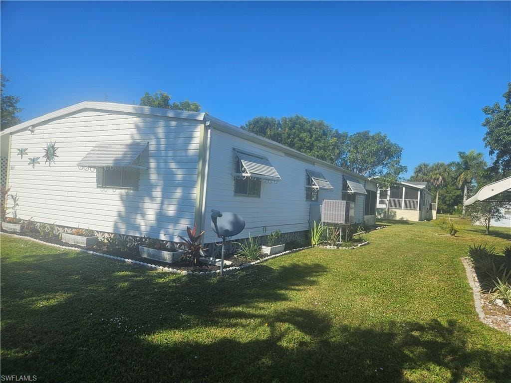 View of side of property with a yard