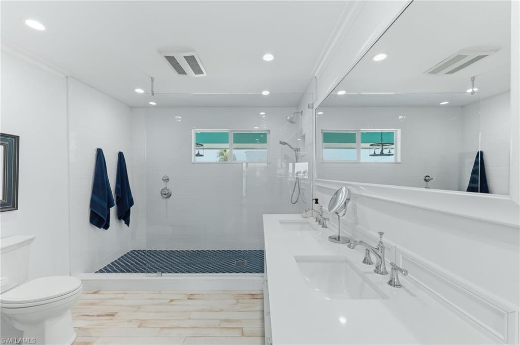 Primary bath with double sinks and newly tiled shower
