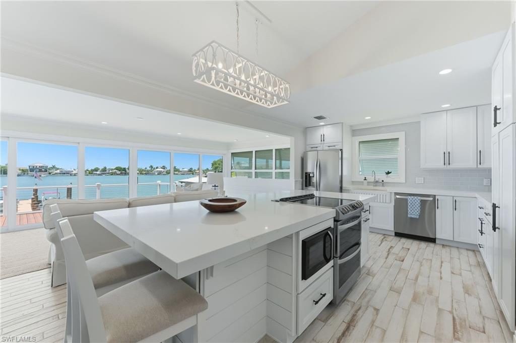 Kitchen with SS appliances and custom pantry