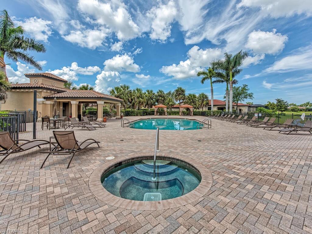 View of swimming pool featuring a patio and a community hot tub