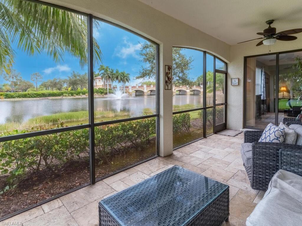 Sunroom / solarium featuring a water view and ceiling fan