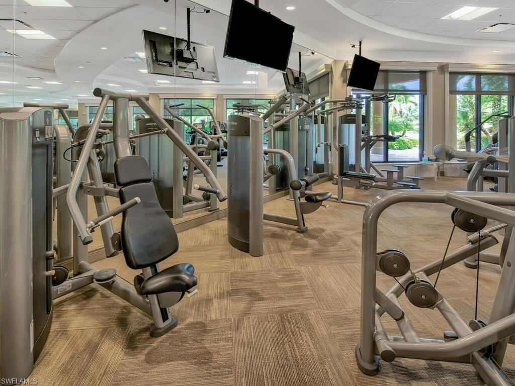 Exercise room featuring light carpet