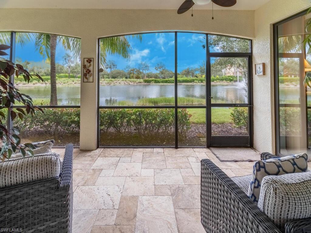 Sunroom featuring a water view and ceiling fan
